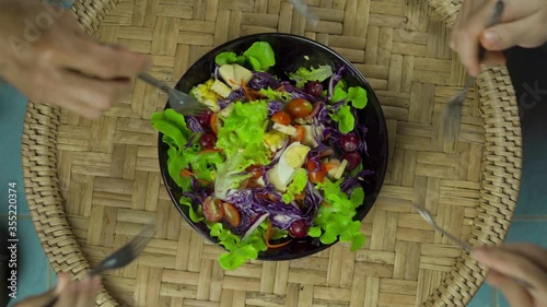 Slow motion,Top view, family is eating salad together,salad beautifully served, healthy food, nutrition