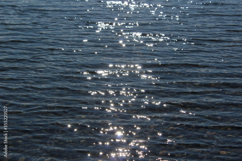Sunlight reflects and sparkles on water in the bay