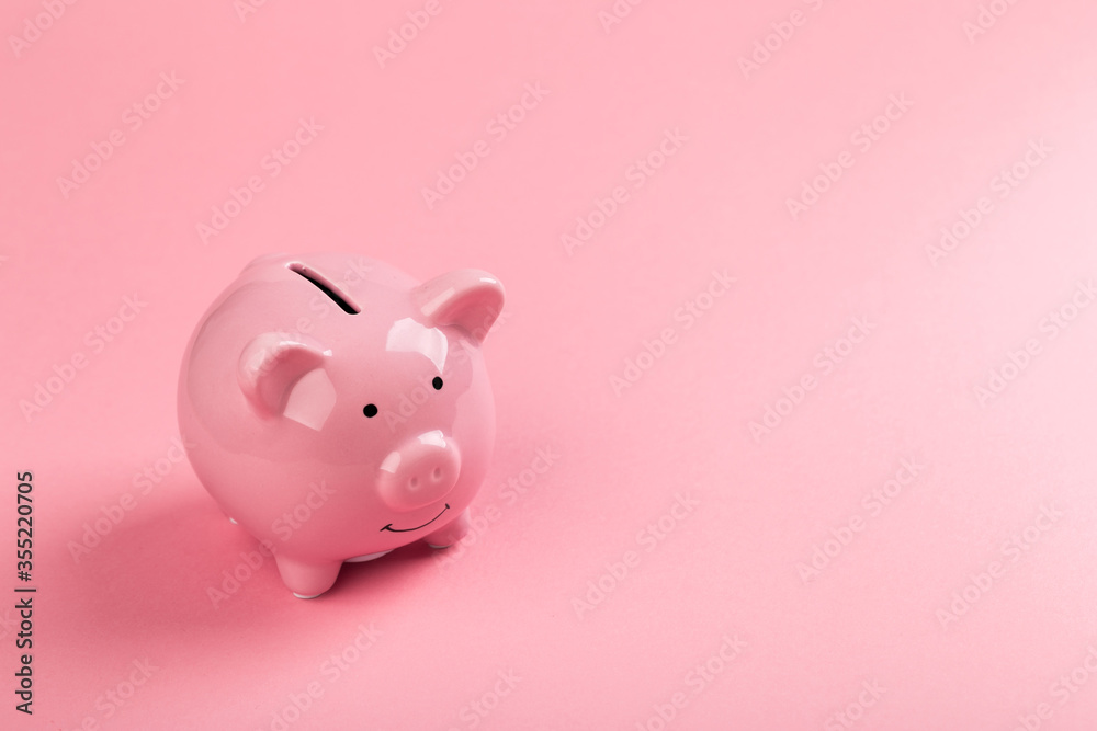 beautiful pink piggy bank on rose background.