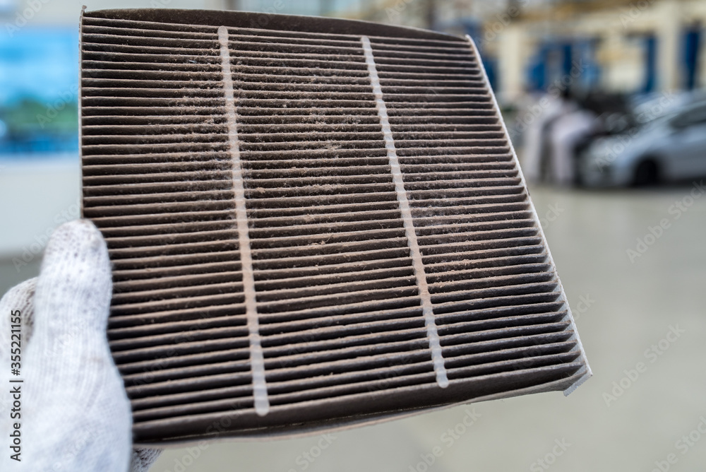 Foto de Car air conditioner filter in the cabin of the car is dirty and damaged by the use of