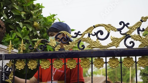 Delivery man carry parcel deliver to young woman customer at home,therefore must wear a mask to prevent the spread of the disease,Social distancing home isolation work concept.
