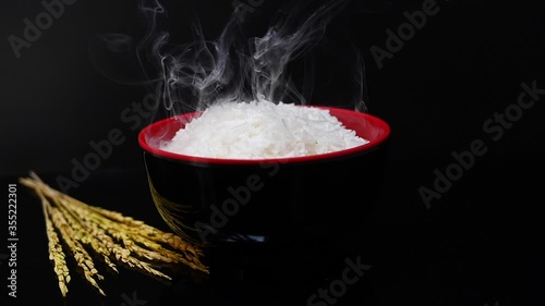 Cooked rice and smoke in a healthy black bowl
