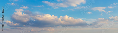 Fototapeta Naklejka Na Ścianę i Meble -  Panorama with curly pink clouds on a blue sky