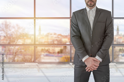 Man in elegant custom tailored expensive suit posing staight in the office photo