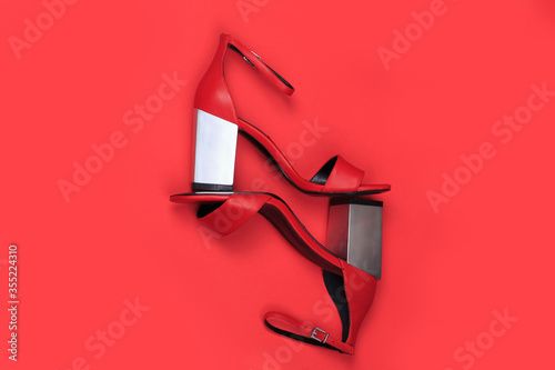 Red high heels women shoes. High fashion luxury female footwear. Creative flat lat top view design concept.
