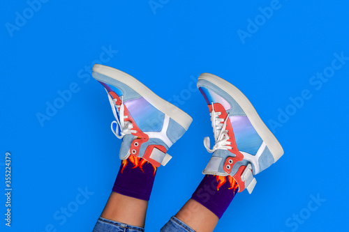 Woman or teenager legs in shoes or boots. Creative fashion footwear design background.