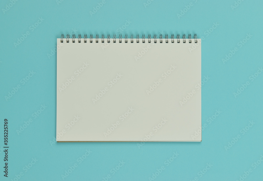 Opened empty notebook on blue background. Top view. copy space. Opened empty notebook on blue background. Top view. copy space.