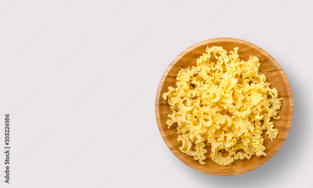 Pasta in a wooden bowl on a white background Pasta in a wooden bowl on a white background