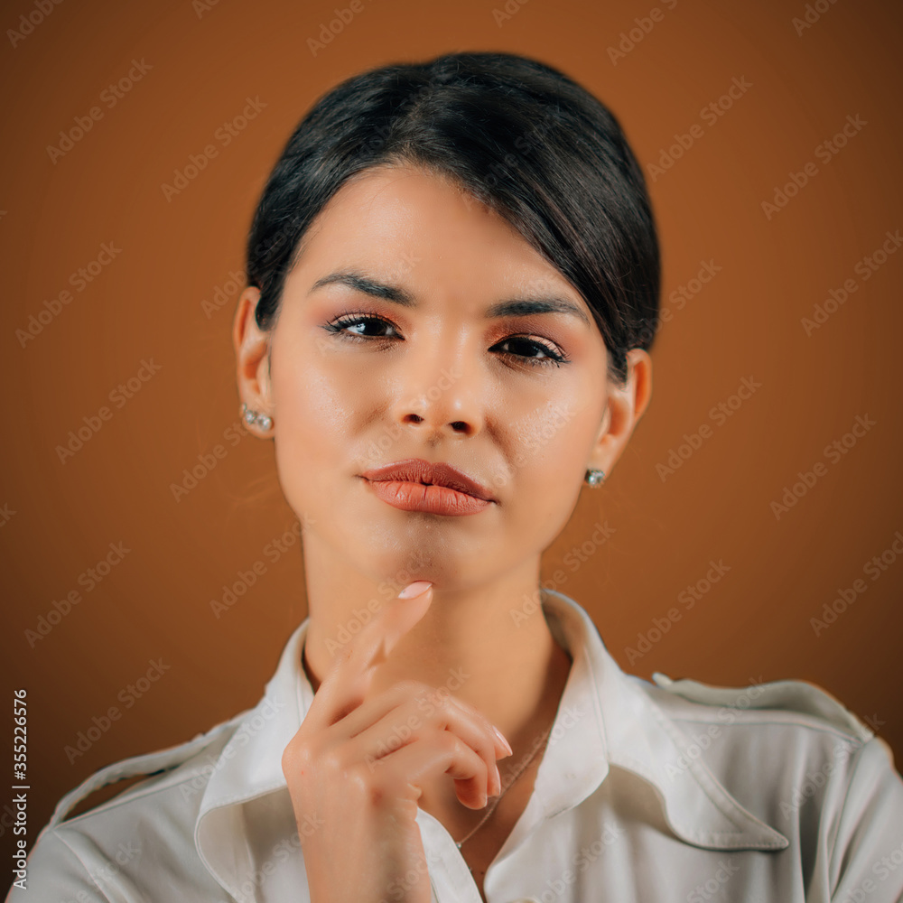 Emotion Curiosity. Portrait of a beautiful curious young woman, studio portrait, orange background Emotion Curiosity. Portrait of a beautiful curious young woman, studio portrait, orange background