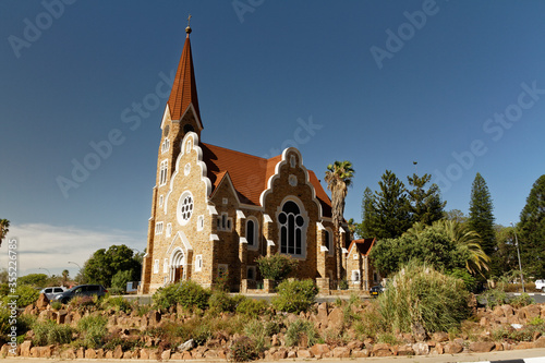 The Christ Church, Christuskirche is a historic landmark and Lutheran church in Windhoek, Namibia. Blue sky and palm trees