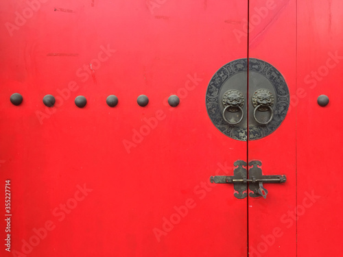 Hand of lion on Oriental lion's red door