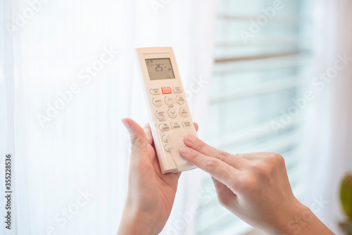 Wallpaper Mural woman is cleaning remote control in house Torontodigital.ca