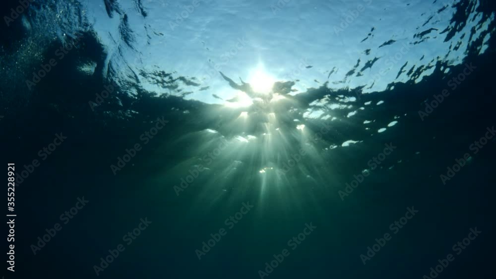 sun ray and sun beam scenery underwater waves on surface of water slow ocean scenery