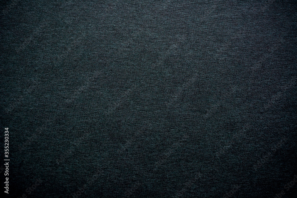 Fine-grained black-gray texture with focus in the center of the frame and above, blurring and darkening of the background at the edges Fine-grained black-gray texture with focus in the center of the frame and above, blurring and darkening of the background at the edges