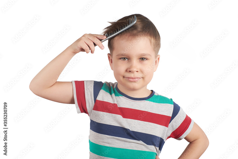 Little boy combing his hair, isolated on white background Little boy combing his hair, isolated on white background
