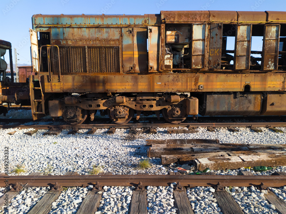 Demolished rusty in a railway junkyard. Dilapidated vintage