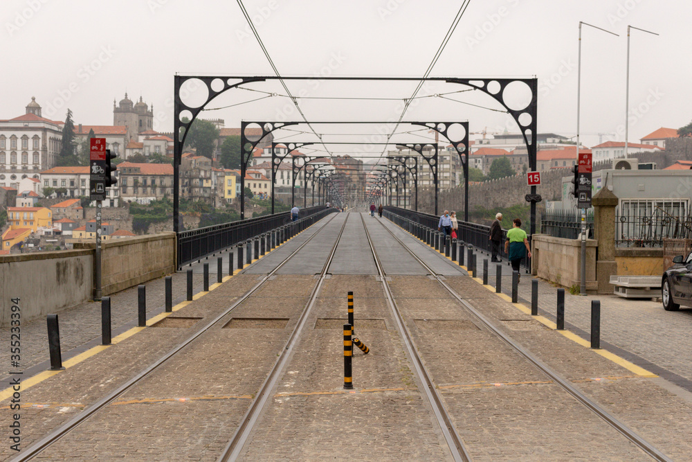 Naklejka premium View from the Dom Luiz I Bridge, rails of the city metro. People walk at Dom Luis bridge, Porto, Portugal.