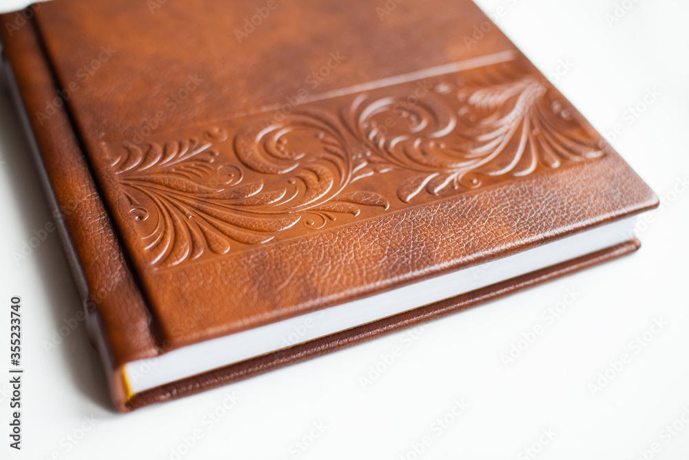 Brown books in leather covers with beautiful pattern Brown books in leather covers with beautiful pattern