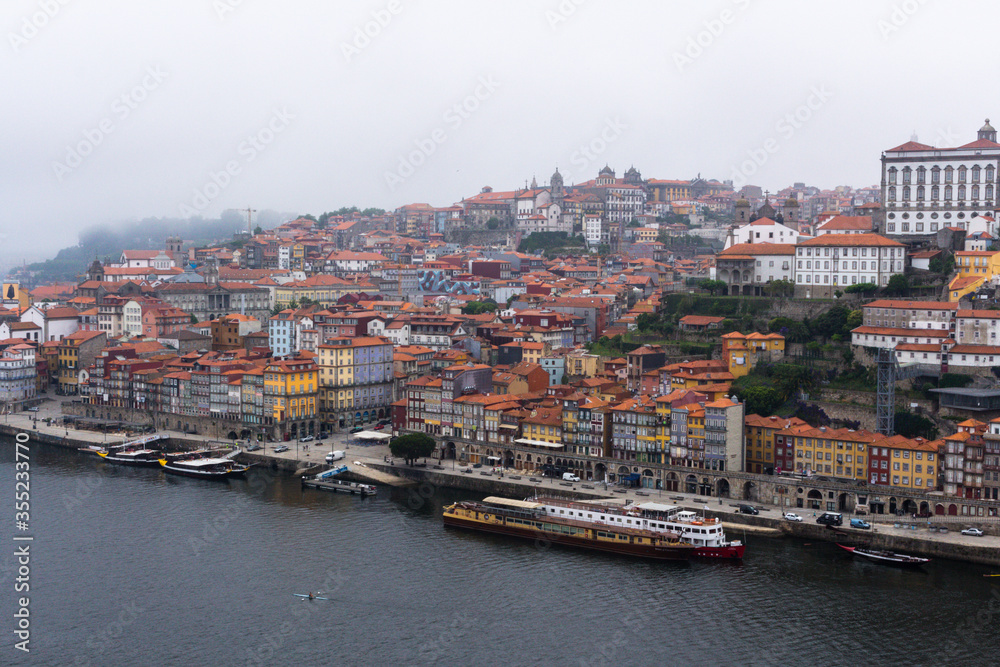 Colorful houses of Porto Ribeira, traditional facades, old multi-colored houses with red roof tiles on the embankment in the city of Porto. Unesco World Heritage site, Portugal.