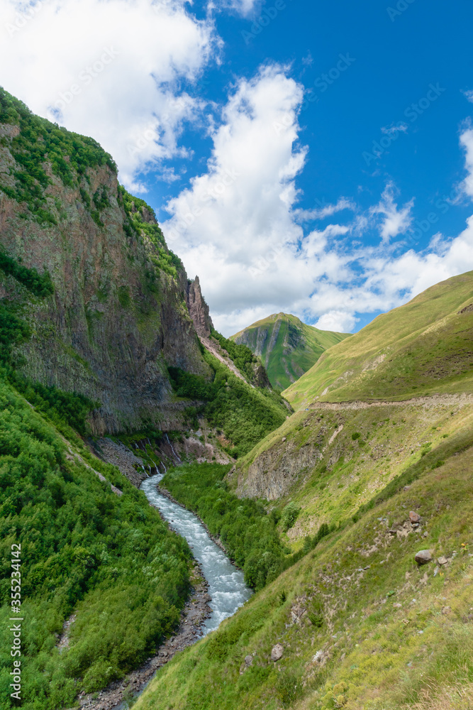 Naklejka premium Truso Valley and Gorge trekking / hiking route landscape, in Kazbegi, Georgia. Truso valley is a scenic trekking route close to the border of North Ossetia.