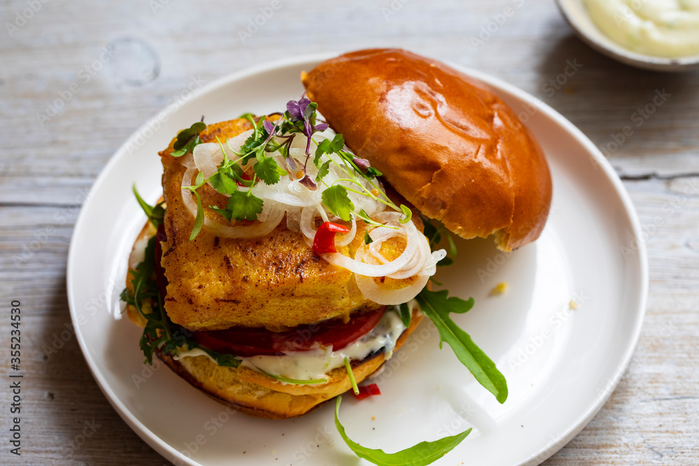 Turmeric fish burger in brioche bun Turmeric fish burger in brioche bun