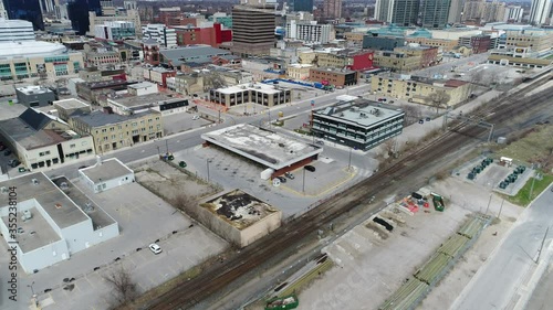 Closeup Aerial Over Empty Industrial Area Towards Commercial Financial District of Downtown Core photo