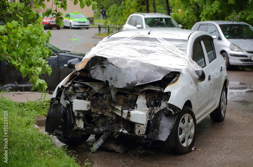 Light grey car after an accident in the Parking lot, podvoysky ulitsa, Saint Petersburg, Russia June 2020 photo