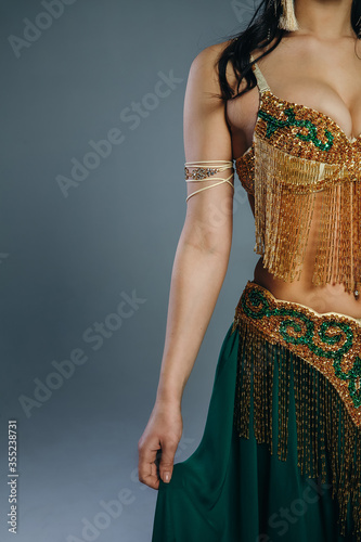 Green Oriental costume details. Indian. Vertical Photo