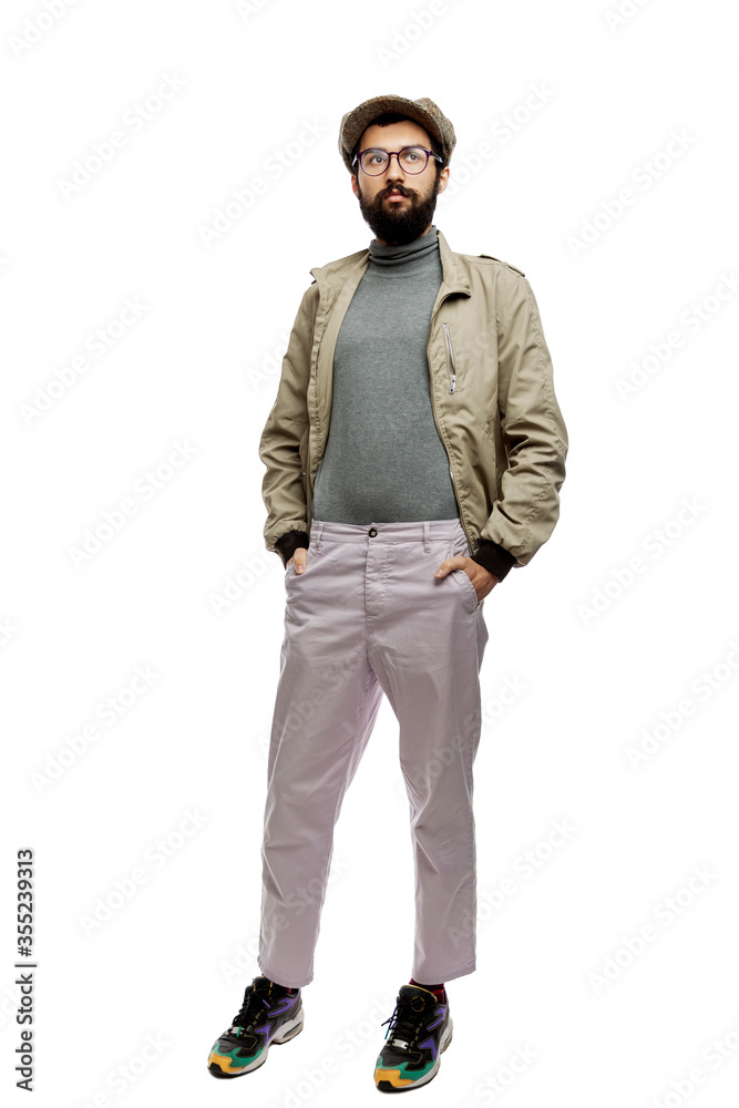 Stylish young man with a beard and a cap. Full height. Isolated on a white background. Vertical. Stylish young man with a beard and a cap. Full height. Isolated on a white background. Vertical.
