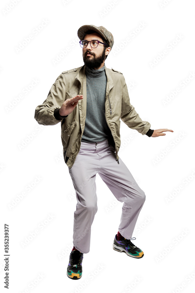 Scared stylishly dressed young man in glasses and with a beard. Full height. Isolated on a white background. Vertical. Scared stylishly dressed young man in glasses and with a beard. Full height. Isolated on a white background. Vertical.