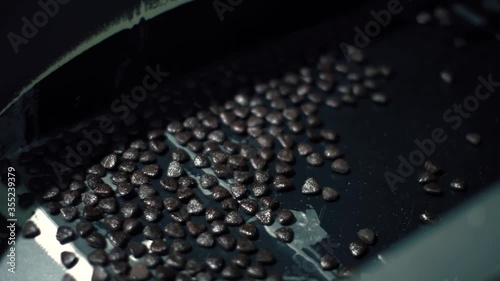 Pet food moves in an convoyer belt in a pet food factory. Equiment of a production line for dog and cat food. Business and factory concept  photo