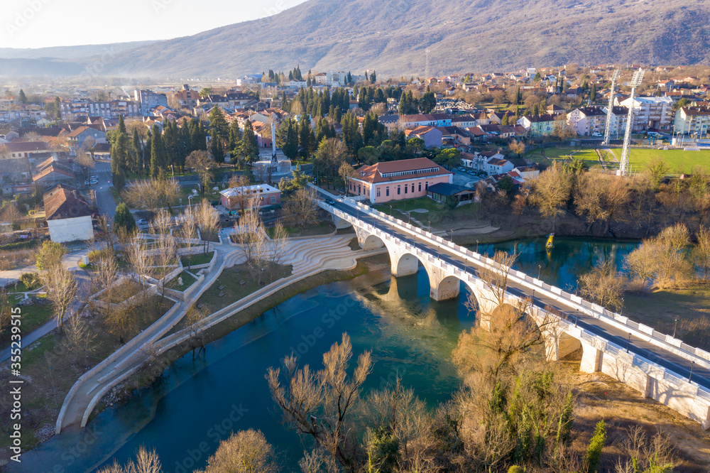 Danilovgrad Montenegro: bridge on Zeta river on the way to Ostrog monastery and the downtown park. Aerial view of the small town in Bjelopavlici.
