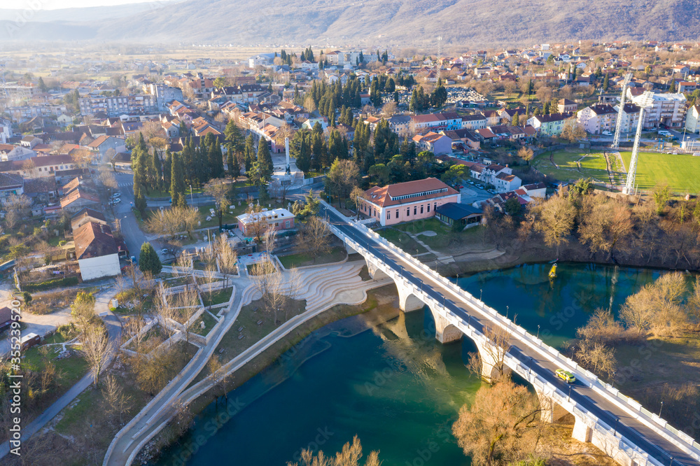 Danilovgrad Montenegro: bridge on Zeta river on the way to Ostrog monastery and the downtown park. Aerial view of the small town in Bjelopavlici.