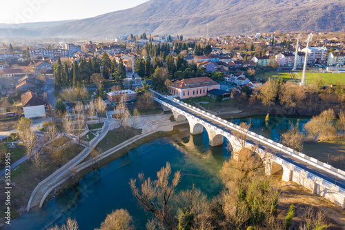 Danilovgrad Montenegro: bridge on Zeta river on the way to Ostrog monastery and the downtown park. Aerial view of the small town in Bjelopavlici. © Predrag Jankovic