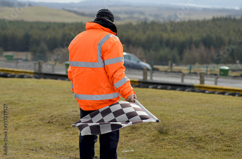 Photos End of the race: marshal with the checkered flag