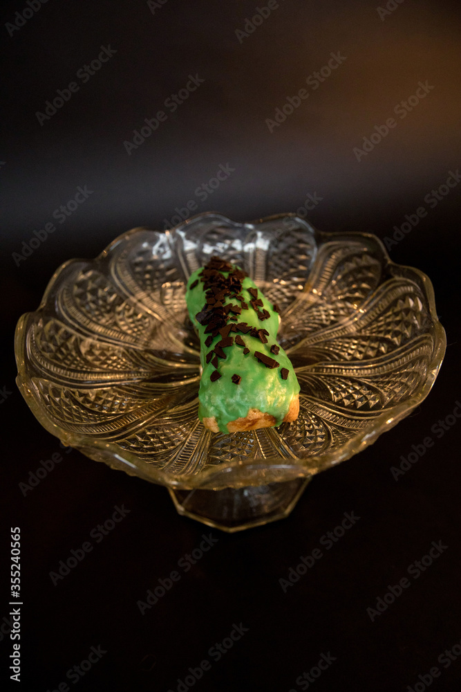 Fototapeta premium Delicious eclair in a crystal vase