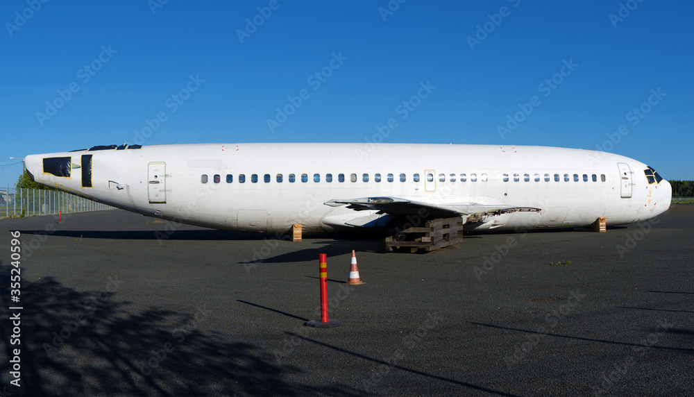 Economic crisis. Disassembled airplane at the airport parking.