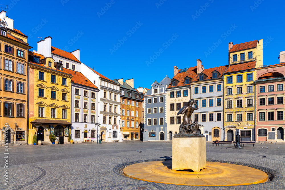 Panoramic view of historic Old Town quarter market square, Rynek Starego Miasta, with colorful tenement houses and Warsaw Mermaid statue in Warsaw, Poland