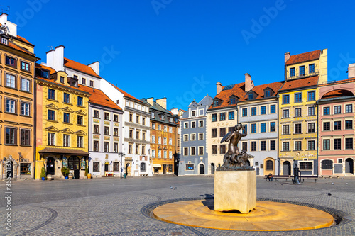 Panoramic view of historic Old Town quarter market square, Rynek Starego Miasta, with colorful tenement houses and Warsaw Mermaid statue in Warsaw, Poland