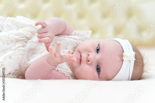 Cute little girl is lying on the bed