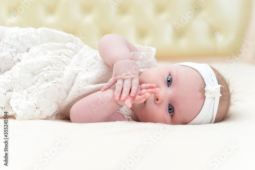 Cute little girl is lying on the bed