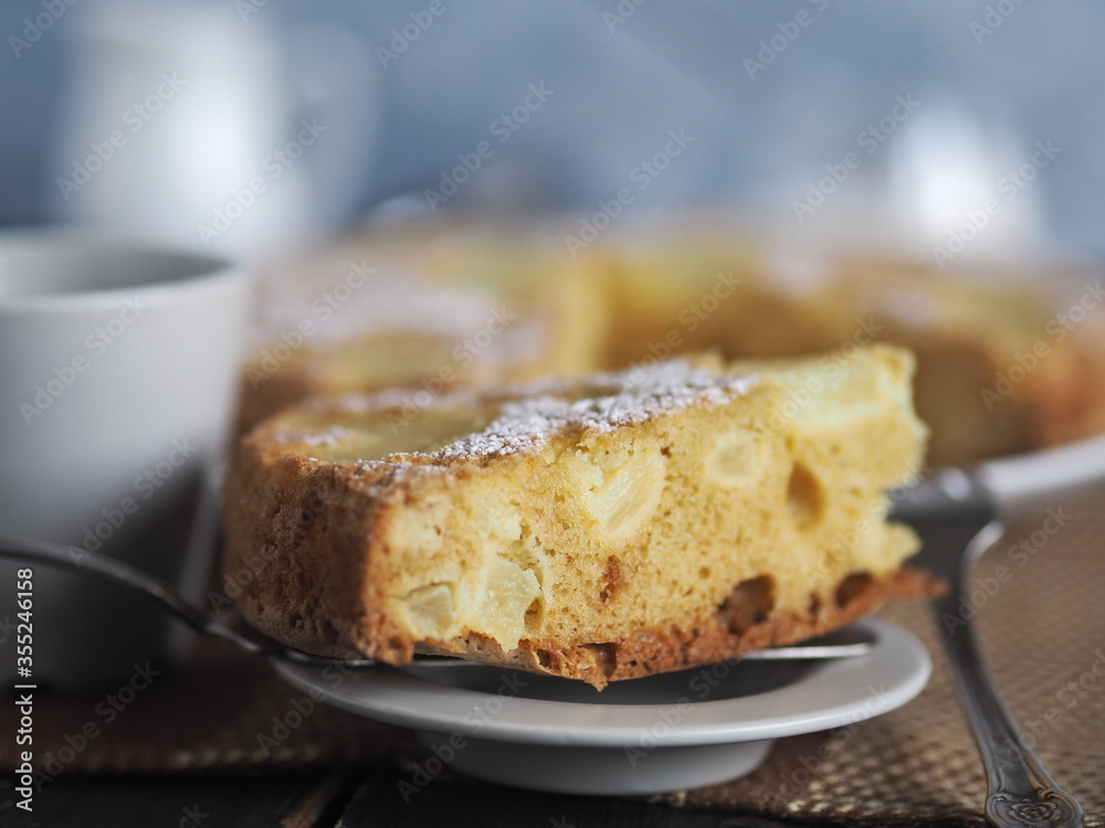Home cooking.Sponge cake with pineapple on a dark background. Home cooking.Sponge cake with pineapple on a dark background.