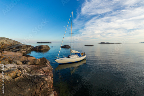 Photography Sailboat moored to barren rock in Stockholm archipelago
