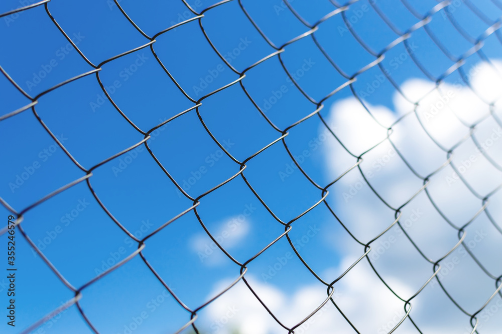 Metal fence close-up. The territory of the fence, against the sky. Metal fence close-up. The territory of the fence, against the sky.