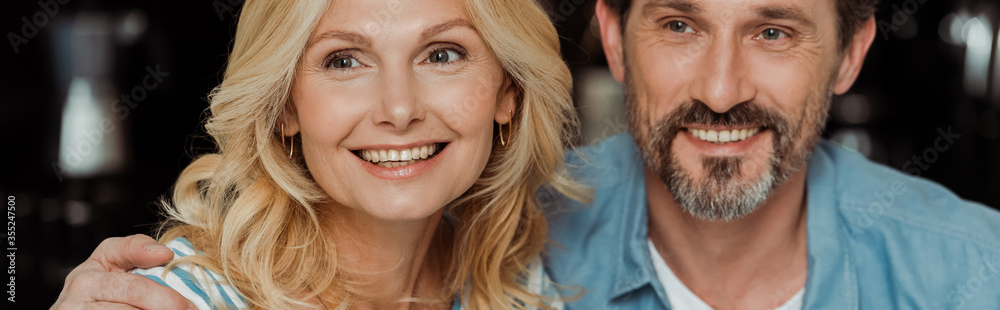 Horizontal crop of smiling man embracing beautiful wife at home Horizontal crop of smiling man embracing beautiful wife at home