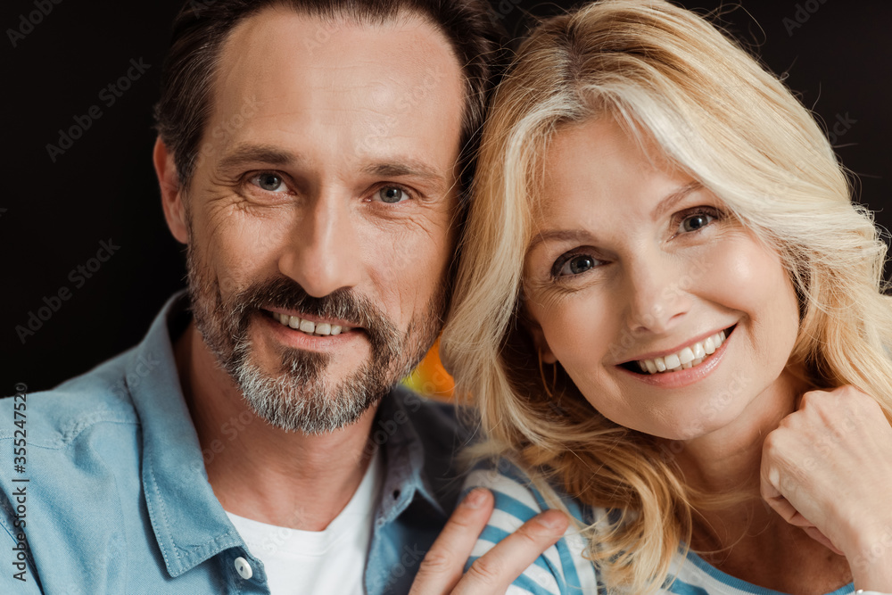 Mature couple smiling at camera at home Mature couple smiling at camera at home