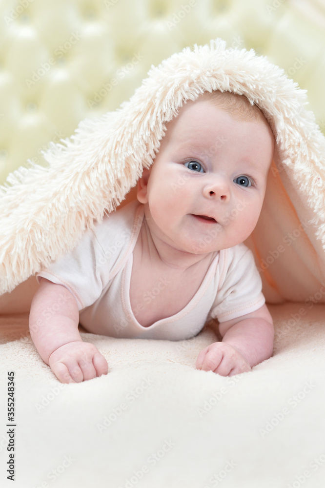 Cute little baby girl playing under the blanket Cute little baby girl playing under the blanket