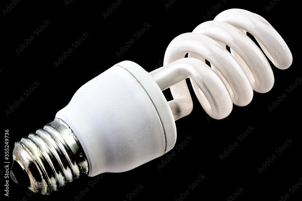 Energy saving bulb isolated on black background close up view Energy saving bulb isolated on black background close up view