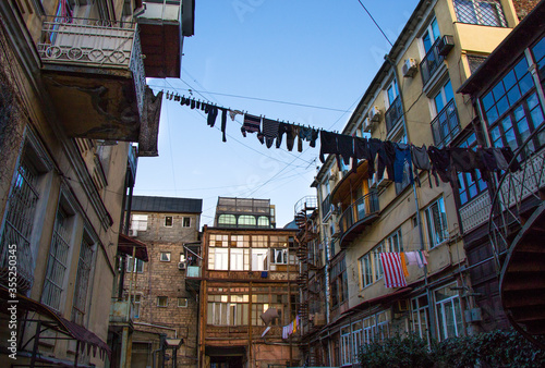 old town house and yard, laundry and wooden buildings. Old style buildings in city center of Tbilisi. photo