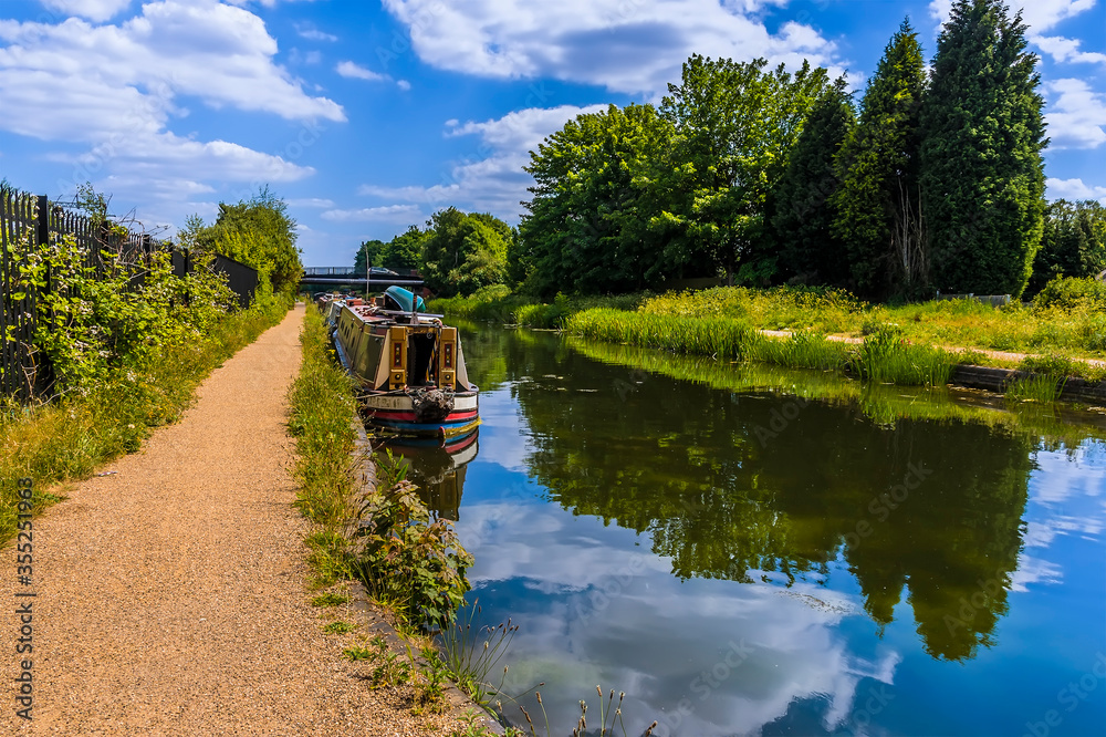 Narrowboats moored on the Birmingham Canal at Tipton in summertime